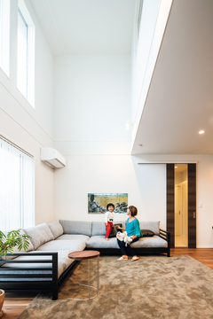 吹き抜けを設けたリビングは、大きな高窓も印象的