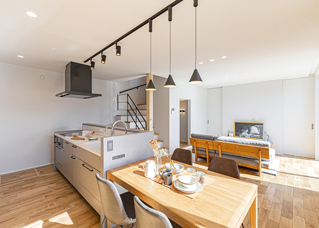 キッチンはアイランド型を採用し、リビング側から手元が見えないようにセニベトン仕上げの腰壁を設置。ダイニングテーブルは配膳や片付けがラクにできるようにキッチンと横並びにし、庭を眺められる位置に配置した