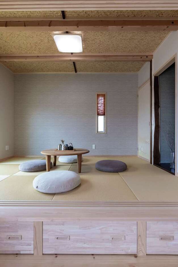 リビング隣の小上がりの和室は玄関から直接出入り可能。天井は数寄屋風、床柱は縁起の良い槐（エンジュ・延寿）を用い、上質で端正な空間に。床下には引き出し収納を設けた