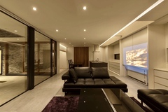 広々としたLDK。落ち着いた色調のインテリアと開放的なガラス窓が、リラックスできる空間を提供している。