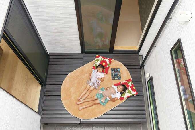 暗くなりがちな玄関にも光を通すパティオ（中庭）。姉妹はここに寝転んで青空を眺めるのが大好き