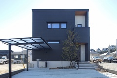 シンプルでモダンな二階建ての外観。広いカーポートと植栽で、機能性と美しさを両立したデザインになっている。【トキワハウス デザイン アンド ビルド（常盤工業）】