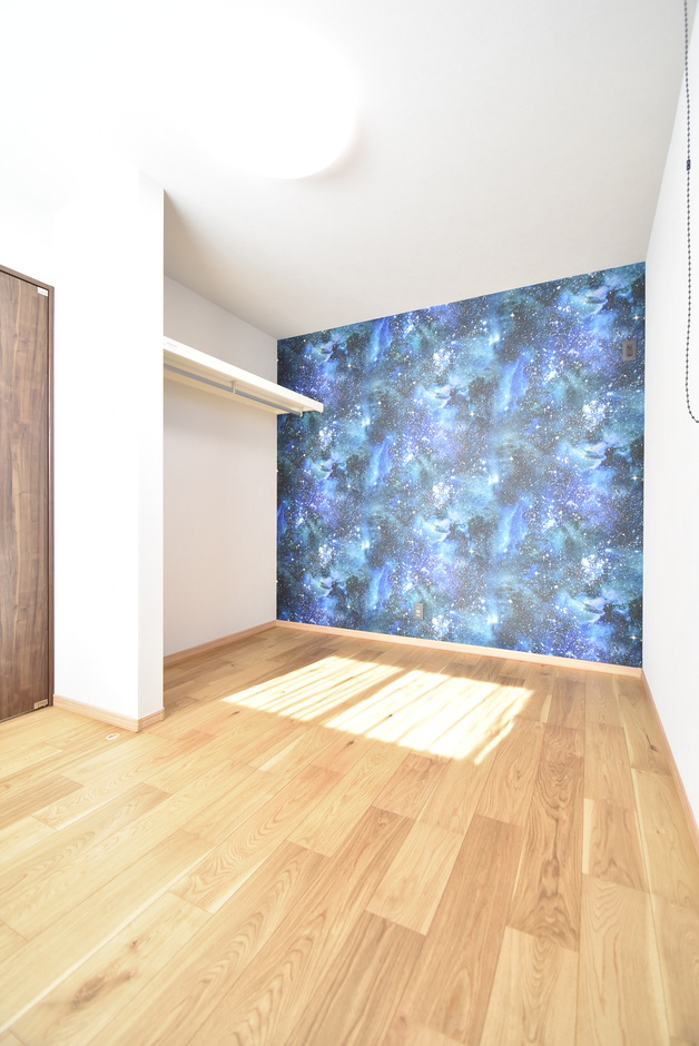 宇宙柄のアクセントクロスが目を惹くこども部屋。