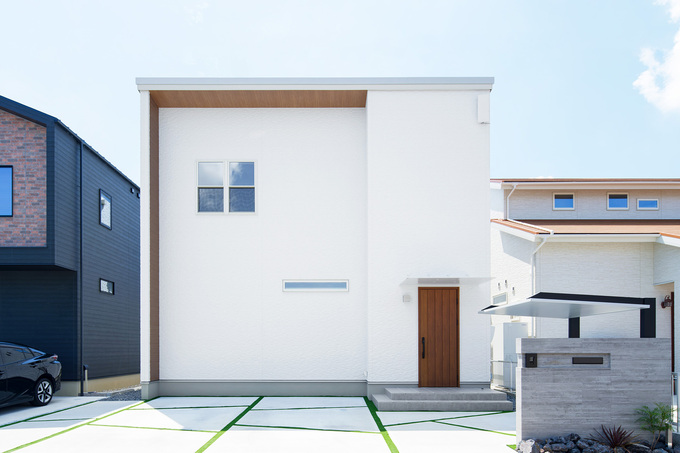 シンプルでおしゃれな雰囲気をイメージした、スクエアのフォルム×白×木目の外観。上げ下げ窓とスリット窓をアクセントにすることで、シンプルでありながらも目を惹く、個性的なデザインに仕上がった。