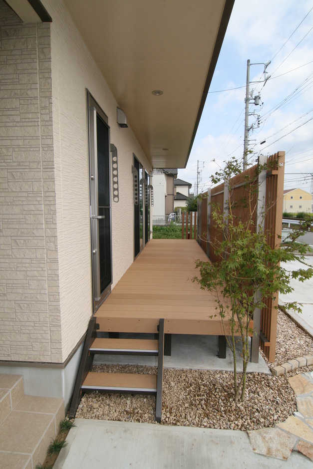ウッドデッキの上は2階のバルコニー。建物の幅いっぱいにのばし布団を各部屋から直接干せることができ、1階の屋根代わりにもなっている