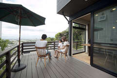 LDKの延長線上に作った広いウッドデッキ。絶景を眺めながらリゾートのようにゆったりとくつろげる