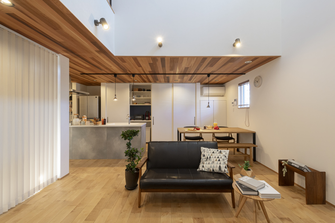 グレーのオープンキッチン。天井にはレッドシダー材をあしらい、かっこよさを演出。