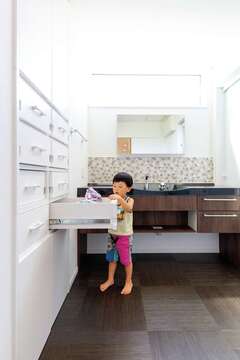 キッチンのバックヤードに造作した特注の収納棚。子どもたちそれぞれの収納棚をつくり、自分でお片づけする習慣が身についた