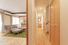 玄関ホールからキッチン、水回りへはまっすぐ伸びる廊下を設けた。家事とくつろぎの動線を分けてすっきり【イーホーム】