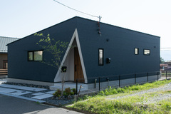 斬新なデザインの建物外観。幾何学的なラインと落ち着いた色調が印象的で、周囲の緑とも調和している。