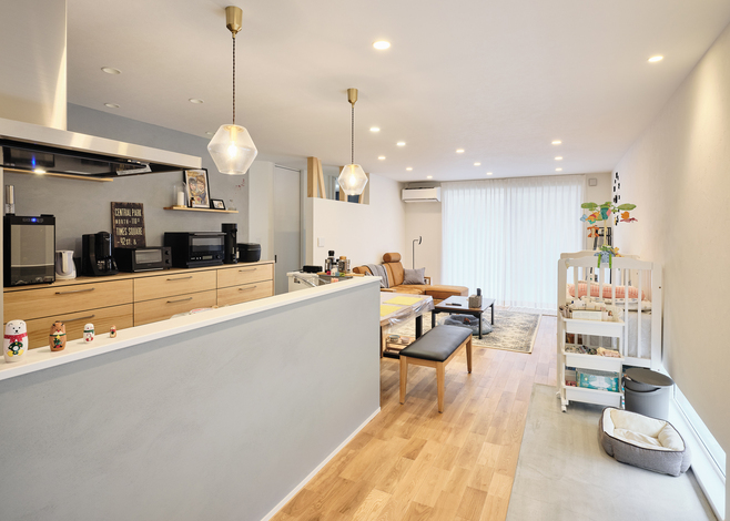 玄関の土間はLDKまで続き、リビングとの境目に段差のないユニバーサルデザインを採用。LDKの土間部分は愛犬の居場所としても活躍する。対面キッチンの腰壁とキッチンの背面の壁は塗り壁で仕上げ、本物素材の質感が室内の雰囲気を引き立てている