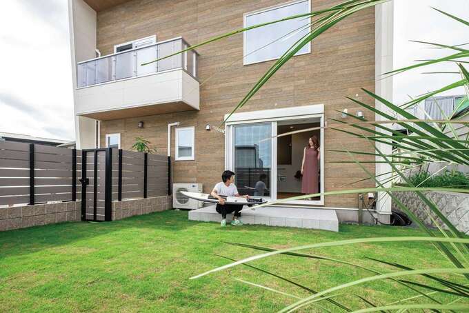 庭のある暮らしに憧れていたお二人。外からの視線が気にならないようフェンスを設け、BBQを楽しんだり、サーフボードの手入れをしたり。夜は美しくライトアップ！