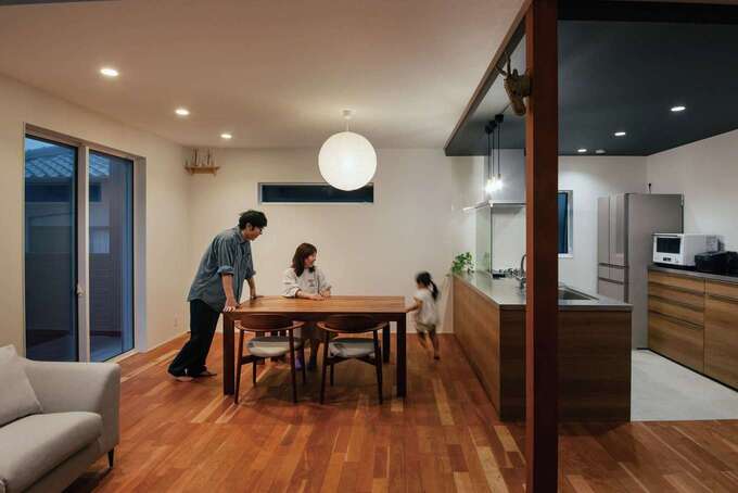 天然木の質感が心地いいナチュラル＆モダンのLDK。和のテイストを感じるダイニングの照明とキッチンの黒い下がり天井がアクセントに