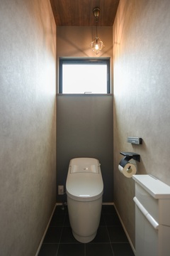 シンプルで落ち着いたトーンのトイレスペース。シーリングライトが柔らかな光を届け、リラックスできる空間を演出。【スズイチ】